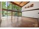 Bright living room featuring hardwood floors, expansive windows, and a vaulted wood ceiling at 3165 Laurel Ridge Nw Rd, Hickory, NC 28601