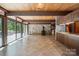 Open-concept living room and kitchen featuring a stone fireplace and expansive windows at 3165 Laurel Ridge Nw Rd, Hickory, NC 28601