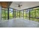 Bright sunroom with walls of windows offering scenic views and herringbone-patterned tile flooring at 3165 Laurel Ridge Nw Rd, Hickory, NC 28601