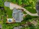 Aerial view showcases this landscaped property with pool, patio, detached garage, circular driveway, and mature trees at 331 Anthony Cir, Charlotte, NC 28211