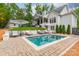 A pristine backyard pool and patio is flanked by lounge seating and manicured landscaping in this relaxing outdoor oasis at 331 Anthony Cir, Charlotte, NC 28211