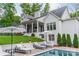 A pristine backyard pool and patio is flanked by lounge seating and manicured landscaping in this relaxing outdoor oasis at 331 Anthony Cir, Charlotte, NC 28211