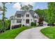 Lovely home with manicured front lawn, mature trees, and a driveway leading to a detached garage at 331 Anthony Cir, Charlotte, NC 28211
