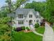 Aerial view of a stately white brick home with lush landscaping and a curved walkway at 331 Anthony Cir, Charlotte, NC 28211