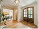 Bright foyer features hardwood floors, a view to a dining area, and arched double doors with glass inserts at 331 Anthony Cir, Charlotte, NC 28211