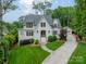 Immaculate two-story home boasts lush landscaping, charming curb appeal, and a private driveway leading to detached garage at 331 Anthony Cir, Charlotte, NC 28211