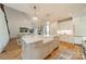 Large kitchen island with a farmhouse sink and bar seating overlooks living area at 331 Anthony Cir, Charlotte, NC 28211