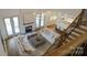 Open-concept living room with fireplace, comfortable sofas, and elegant chandelier lighting at 331 Anthony Cir, Charlotte, NC 28211
