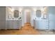 Elegant main bathroom features dual vanities with framed mirrors and ample cabinet space on hardwood floors at 331 Anthony Cir, Charlotte, NC 28211