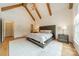 Spacious main bedroom boasts hardwood floors, vaulted ceilings with wood beams, and an abundance of natural light at 331 Anthony Cir, Charlotte, NC 28211