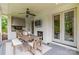 Elegant outdoor kitchen and dining area with a fireplace and adjacent access to the home's interior at 331 Anthony Cir, Charlotte, NC 28211