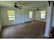 Living room featuring carpet, with multiple windows and ceiling fans providing ample natural light at 4194 Buffalo Shoals Rd, Maiden, NC 28650