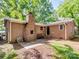 Brick house backyard with brick fireplace, patio, and green space offers outdoor enjoyment at 500 Colony Acres Dr, Charlotte, NC 28217