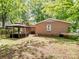 Backyard view showcases a gazebo, house exterior, and surrounding greenery, creating a tranquil outdoor space at 500 Colony Acres Dr, Charlotte, NC 28217