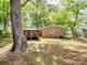Spacious backyard with gazebo, brick house, mature trees, and room for recreation at 500 Colony Acres Dr, Charlotte, NC 28217