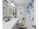 Well-lit bathroom with a modern vanity, black faucet, and blue floral shower curtain at 500 Colony Acres Dr, Charlotte, NC 28217