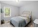Cozy bedroom featuring a decorative bed frame, plush bedding, and natural light from the window at 500 Colony Acres Dr, Charlotte, NC 28217