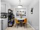 Cozy dining area features bright yellow chairs, a pendant light, and backyard access at 500 Colony Acres Dr, Charlotte, NC 28217
