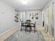 Bright dining room featuring a modern table, soft rug, and view into other rooms at 500 Colony Acres Dr, Charlotte, NC 28217