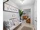 Welcoming entryway with a cushioned bench, decorative pillows, and an inviting 'Stay Awhile' sign at 500 Colony Acres Dr, Charlotte, NC 28217