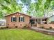 Charming brick home featuring a well-maintained lawn, mature trees, and lovely curb appeal at 500 Colony Acres Dr, Charlotte, NC 28217