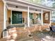 Welcoming front porch features a dark door, rocking chairs, and cozy decor at 500 Colony Acres Dr, Charlotte, NC 28217