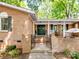 Inviting front porch with black door, decorative wreath, iron gate, and brick accents at 500 Colony Acres Dr, Charlotte, NC 28217