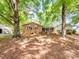 Charming brick home featuring a spacious front yard, mature trees, and outdoor fire pit at 500 Colony Acres Dr, Charlotte, NC 28217