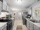 Well-lit kitchen featuring stainless steel appliances, tile backsplash, and ample cabinet space at 500 Colony Acres Dr, Charlotte, NC 28217