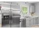 Modern kitchen featuring stainless steel appliances, a double sink, and bright natural light at 500 Colony Acres Dr, Charlotte, NC 28217
