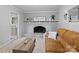 Comfortable living room featuring a painted brick fireplace and stylish decor at 500 Colony Acres Dr, Charlotte, NC 28217