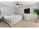Serene bedroom with a floral-patterned bedspread, ceiling fan, and a bright window at 500 Colony Acres Dr, Charlotte, NC 28217