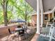 Covered patio with outdoor dining set, brick accent wall, and view of the yard, ideal for relaxation at 500 Colony Acres Dr, Charlotte, NC 28217