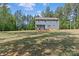 Large backyard with deck for entertaining, shaded by mature trees at 539 Morrison Farm Rd, Troutman, NC 28166