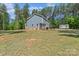 Generous backyard space, featuring a deck and shed surrounded by trees at 539 Morrison Farm Rd, Troutman, NC 28166