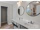 Modern bathroom with dual round mirrors and a white countertop at 539 Morrison Farm Rd, Troutman, NC 28166