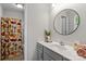 Stylish bathroom with a patterned shower curtain and circular mirror at 539 Morrison Farm Rd, Troutman, NC 28166