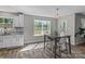 View of an open-concept dining area featuring table, chairs, window, and hardwood floors at 539 Morrison Farm Rd, Troutman, NC 28166