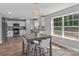 Open floor plan with kitchen and dining area featuring natural light and white cabinets at 539 Morrison Farm Rd, Troutman, NC 28166