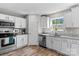View of a kitchen featuring stainless steel appliances, white cabinets and granite countertops at 539 Morrison Farm Rd, Troutman, NC 28166