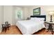 Bright bedroom with a large comfortable bed, hardwood floors, and neutral decor at 704 Kingman Dr, Charlotte, NC 28217