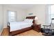 Cozy bedroom with hardwood floors, a comfortable bed, and a classic rocking chair at 704 Kingman Dr, Charlotte, NC 28217