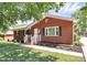 Quaint brick home with a well-kept lawn, a small garden and an American flag on display at 704 Kingman Dr, Charlotte, NC 28217