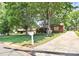 Charming brick home with a well-manicured lawn and a long driveway at 704 Kingman Dr, Charlotte, NC 28217