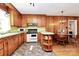 Charming kitchen featuring wood cabinets, flooring, and adjacent dining area at 704 Kingman Dr, Charlotte, NC 28217