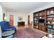 Cozy living space with wood floors, featuring a stately bookshelf and comfortable furniture arrangement at 704 Kingman Dr, Charlotte, NC 28217