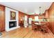 Warm living space featuring a brick fireplace, hardwood floors, and a classic eat-in kitchen area at 704 Kingman Dr, Charlotte, NC 28217
