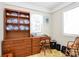 Bright home office with wooden desk and hutch, providing ample storage and workspace at 704 Kingman Dr, Charlotte, NC 28217
