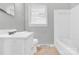 Clean, all-white bathroom with a tub shower at 735 Wilbrown Cir, Charlotte, NC 28217