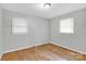 This empty bedroom features hardwood floors and lots of natural light at 735 Wilbrown Cir, Charlotte, NC 28217